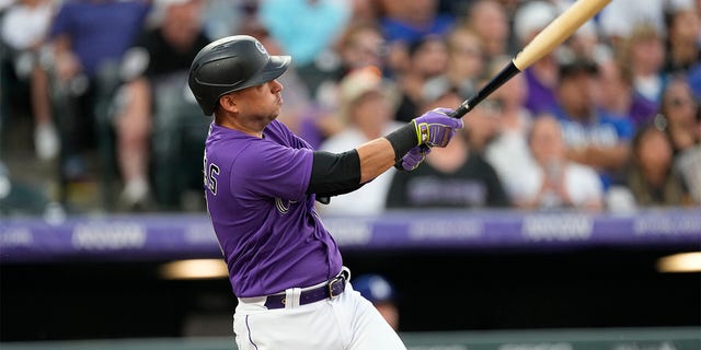 Colorado Rockies' Jose Iglesias follows the flight of his two-run home run off Los Angeles Dodgers starting pitcher Tyler Anderson during the sixth inning of a baseball game Monday, June 27, 2022, in Denver.