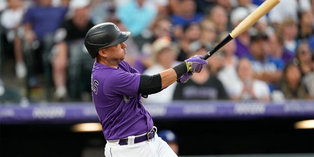 Colorado Rockies' Jose Iglesias follows the flight of his two-run home run off Los Angeles Dodgers starting pitcher Tyler Anderson during the sixth inning of a baseball game Monday, June 27, 2022, in Denver.