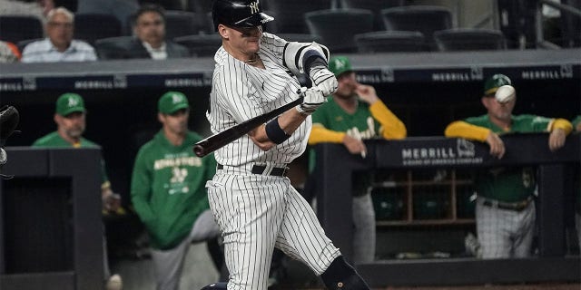 New York Yankees' Josh Donaldson strikes a pitch for a double that drives in two runs during the seventh inning of a baseball game against the Oakland Athletics, Monday, June 27, 2022, in New York. 