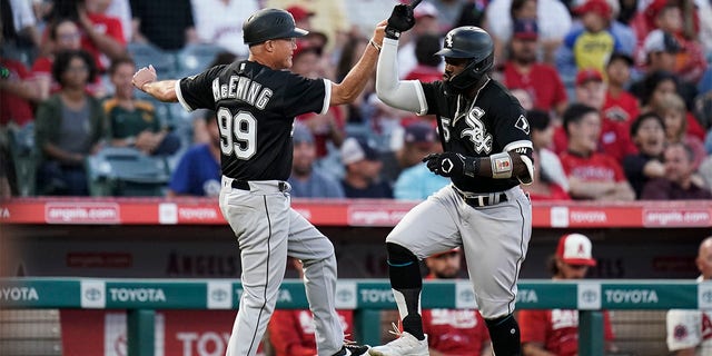 Josh Harrison of the Chicago White Sox, right, is the third base coach Joe to make a two-run home run with the Los Angeles Angels during five innings of a baseball game in Anaheim, California, Tuesday, June 28, 2022. Celebrate with McEwing. 