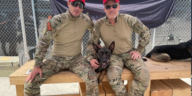 Benghazi survivor Mark "Oz" Geist (R) poses with Joshua Perry of Baden K9 while wearing "Make 22 Zero Again." The number 22 refers to the estimated number of American veterans who die by suicide each day. After the 2012 Benghazi attack, Geist started a nonprofit called Shadow Warriors which pairs veterans with service dogs.