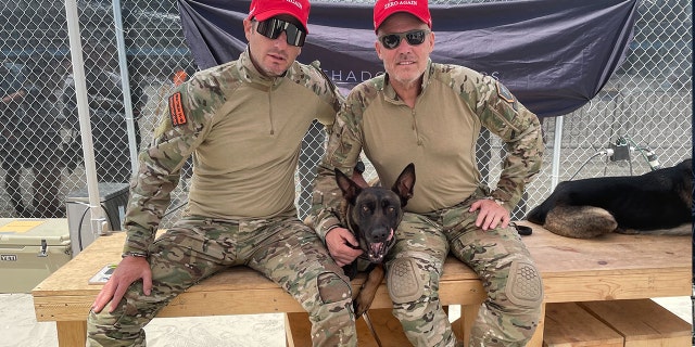 Benghazi survivor Mark "Oz" Geist (R) poses with Joshua Perry of Baden K9 while wearing "Make 22 Zero Again." The number 22 refers to the estimated number of American veterans who die by suicide each day. After the 2012 Benghazi attack, Geist started a nonprofit called Shadow Warriors which pairs veterans with service dogs.