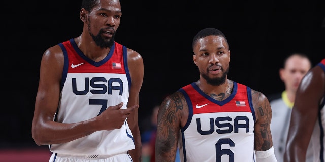 Kevin Durant (7) of the United States talks with Damian Lillard (6) during a men's basketball semifinal between the United States and Australia at the Tokyo 2020 Olympic Games in Saitama, Japan, Aug. 5, 2021.