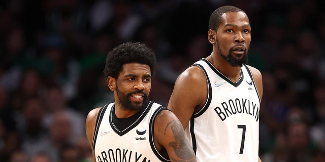 Kyrie Irving (11) and Kevin Durant (7) of the Brooklyn Nets during the first quarter of Game 1 of the 2022 NBA Eastern Conference first round playoffs against the Boston Celtics at TD Garden April 17, 2022, in Boston.