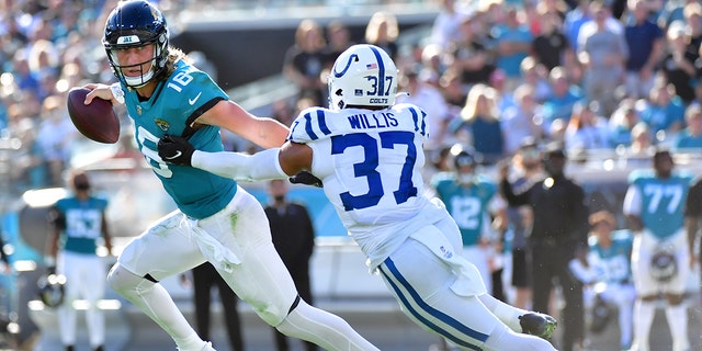 Trevor Lawrence #16 of the Jacksonville Jaguars scrambles while being chased by Khari Willis #37 of the Indianapolis Colts during the fourth quarter at TIAA Bank Field on Jan. 9, 2022 in Jacksonville, Florida. 
