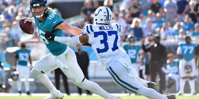 Trevor Lawrence #16 of the Jacksonville Jaguars scrambles while being chased by Khari Willis #37 of the Indianapolis Colts during the fourth quarter at TIAA Bank Field on Jan. 9, 2022 in Jacksonville, Florida. 