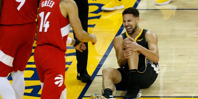 Klay Thompson of the Golden State Warriors reacts after hurting his leg during the NBA Finals game against the Toronto Raptors on June 13, 2019, in Oakland, California.