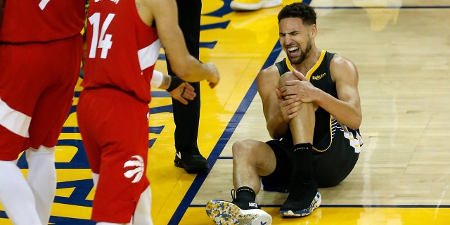 Klay Thompson of the Golden State Warriors reacts after hurting his leg during the NBA Finals game against the Toronto Raptors on June 13, 2019, in Oakland, California.