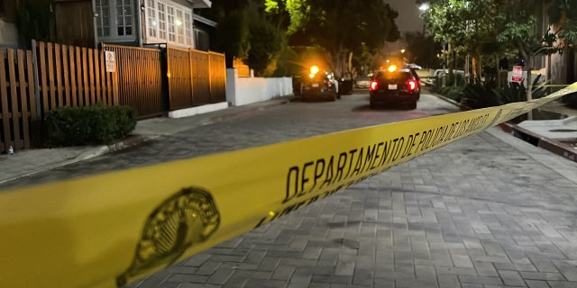 Los Angeles police block off a street in Hollywood near where two people were shot and killed Wednesday night.