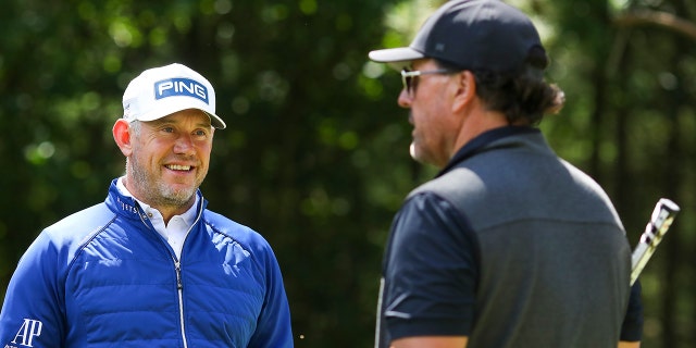 Lee Westwood talks to Phil Mickelson during the Pro-Am ahead of the LIV Golf Invitational on June 8, 2022, in St Albans.