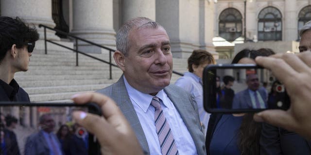 Lev Parnas, center, speaks to the media outside the federal courthouse in New York, Wednesday, June 29, 2022.  Parnas, an associate of Rudy Giuliani who was a figure in President Donald Trump's first impeachment investigation, was sentenced Wednesday to a year and eight months in prison for fraud and campaign finance crimes.  