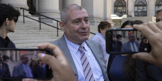 Lev Parnas, center, speaks to the media outside the federal courthouse in New York, Wednesday, June 29, 2022.  Parnas, an associate of Rudy Giuliani who was a figure in President Donald Trump's first impeachment investigation, was sentenced Wednesday to a year and eight months in prison for fraud and campaign finance crimes.  