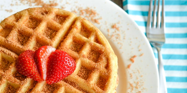 Churros waffles can be serves with strawberries, or any fruit you desire.