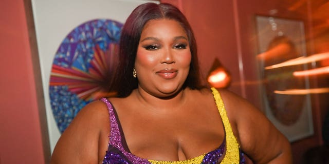 Lizzo admitted she wouldn't have been able to listen to the music she creates now when she was growing up due to her religious upbringing.