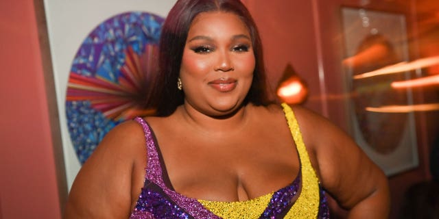 Lizzo admitted she wouldn't have been able to listen to the music she creates now when she was growing up due to her religious upbringing.