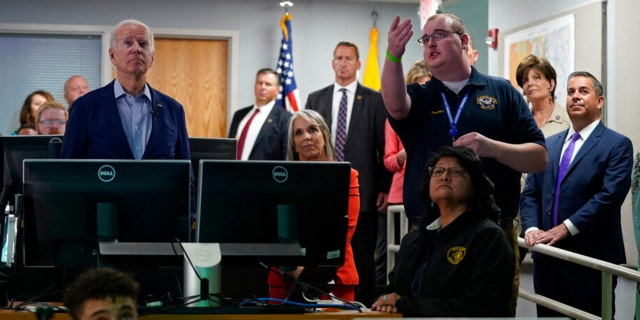 President Biden, left, takes a tour with Mark Chappell, an operations manager with the New Mexico Department of Homeland Security & Emergency Management, at the New Mexico State Emergency Operations Center, Saturday, June 11, 2022, in Santa Fe, N.M.
