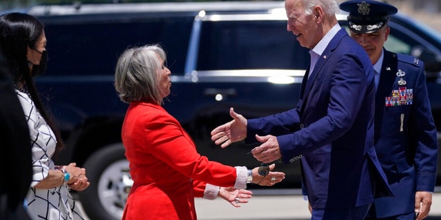 New Mexico Gov. Michelle Lujan Grisham, left, greets President Biden at Kirtland Air Force Base during a trip to meet with state and local officials on the New Mexico wildfires, Saturday, June 11, 2022, in Albuquerque, N.M. 