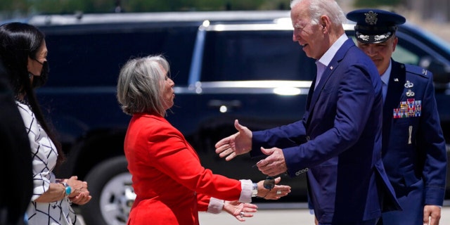 New Mexico Gov. Michelle Lujan Grisham, left, greets President Biden at Kirtland Air Force Base during a trip to meet with state and local officials on the New Mexico wildfires, Saturday, June 11, 2022, in Albuquerque, N.M.