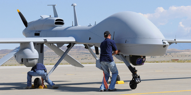 Workers prepare an MQ-1C Gray Eagle unmanned aerial vehicle for static display at Michael Army Airfield, Dugway Proving Ground in Utah in September 2011.