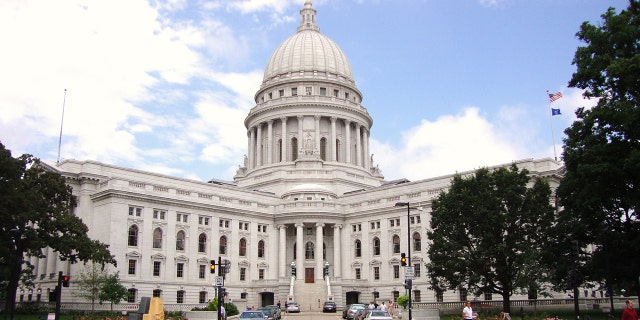 The Wisconsin State Capitol, in Madison, Wisconsin, houses both chambers of the Wisconsin legislature along with the Wisconsin Supreme Court and the Office of the Governor. 