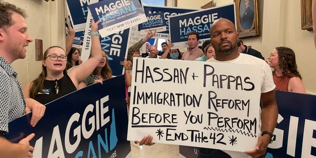 Immigration activists protesting Sen. Maggie Hassan's border security stance are outnumbered by Hassan supporters as the Democratic senator from New Hampshire arrives at the State House to file for re-election, on June 10, 2022 in Concord, N.H.