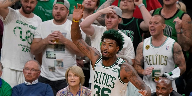 Boston Celtics guard Marcus Smart (36) reacts against the Golden State Warriors during the fourth quarter of Game 3 of basketball's NBA Finals, Wednesday, June 8, 2022, in Boston. 