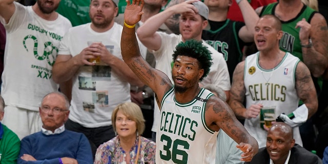 Boston Celtics guard Marcus Smart (36) reacts against the Golden State Warriors during the fourth quarter of Game 3 of basketball's NBA Finals, Wednesday, June 8, 2022, in Boston. 