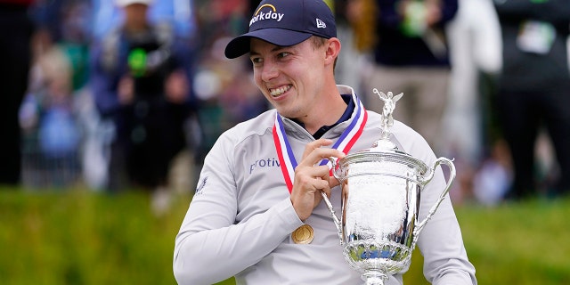 Matthew Fitzpatrick, of England, celebrates with the trophy after winning the U.S. Open golf tournament at The Country Club, Sunday, June 19, 2022, in Brookline, Mass. 