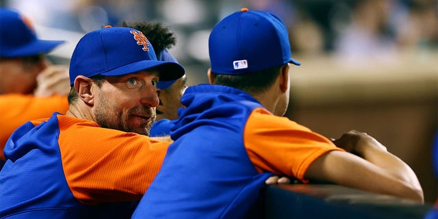 New York Mets pitchers Max Schazer #21 and Jacob deGrom #40 talk in the dugout during a game against the Milwaukee Brewers at Citi Field on June 14, 2022 in New York City.  The Mets beat the Brewers 4-0. 