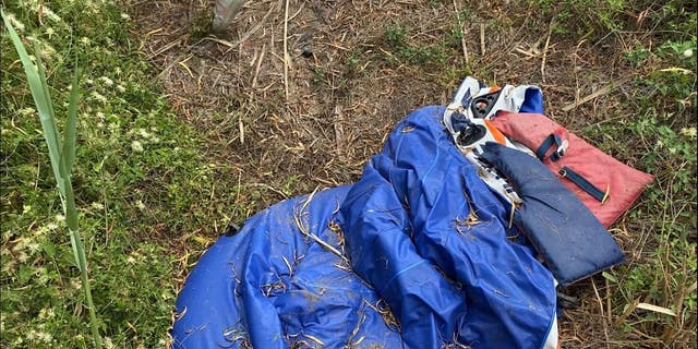 A life vest and a deflated raft are left in the brush on the US side of the Rio Grande, as seen on a tour of the river with the Texas Department of Public Safety.  When trafficked heavily, the grass becomes pushed down around these landing areas, creating easily distinguishable paths. 