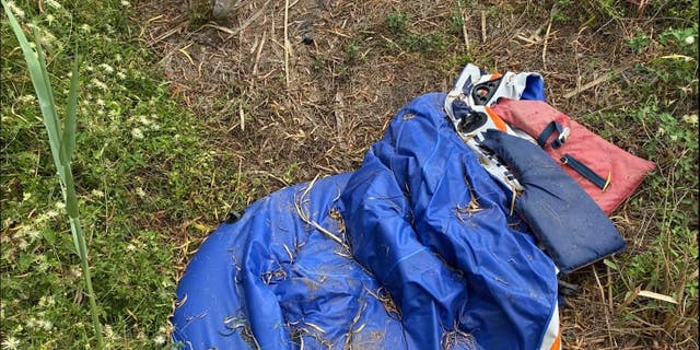 A life vest and a deflated raft are left in the brush on the U.S. side of the Rio Grande, as seen on a tour of the river with the Texas Department of Public Safety. When trafficked heavily, the grass becomes pushed down around these landing areas, creating easily distinguishable paths. 