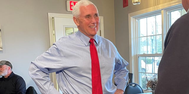 Former Vice President Mike Pence, during a trip to New Hampshire, greets customers at Simply Delicious Bakery in Bedford, N.H., on Dec. 8, 2021