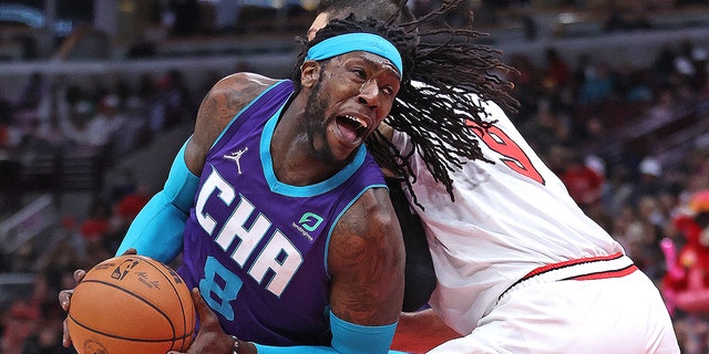 Montrezl Harrell #8 of the Charlotte Hornets drives against Nikola Vucevic #9 of the Chicago Bulls at the United Center on April 08, 2022 in Chicago, Illinois.