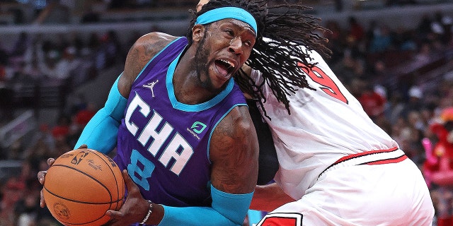 Montrezl Harrell #8 of the Charlotte Hornets drives against Nikola Vucevic #9 of the Chicago Bulls at the United Center on April 08, 2022 in Chicago, Illinois.