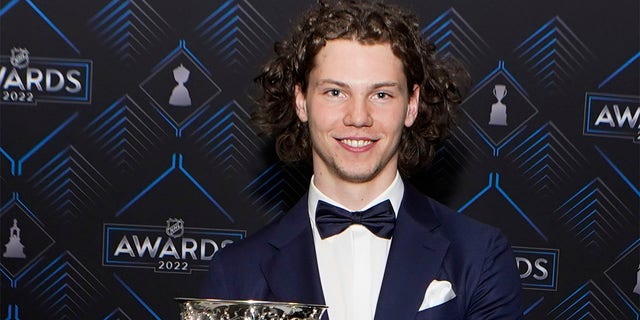 Moritz Seider of the Detroit Red Wings poses with the Calder Trophy after the NHL hockey awards Tuesday, June 21, 2022, in Tampa, Fla.  The Calder Trophy is awarded annually to the league's top rookie. 