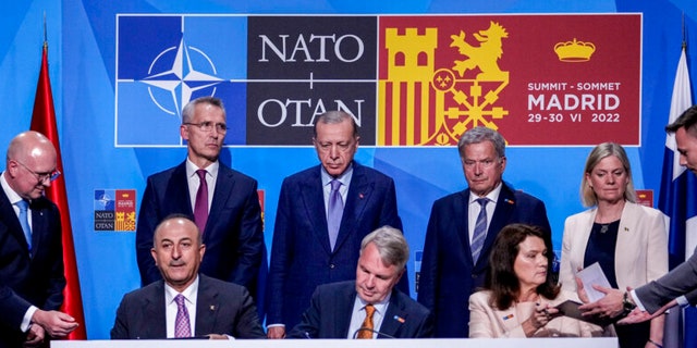 Left to right background: NATO Secretary General Jens Stoltenberg, Turkish President Recep Tayyip Erdogan, Finnish President Sauli Niinisto, Swedish Prime Minister Magdalena Anderson, Turkish Foreign Minister Mevrut Cavshoglu, and Finnish Pekka Haavist. Foreign Minister, Swedish Foreign Minister Ann Linde signs memorandum Turkey agrees to join Finland and Sweden in defense alliance on Tuesday, June 28, 2022 in Madrid, Spain. 