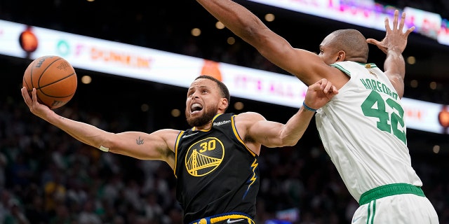 Golden State Warriors guard Stephen Curry (30) goes up for a shot against Boston Celtics center Al Horford (42) during the fourth quarter of Game 4 of basketball's NBA Finals, Friday, June 10, 2022, in Boston. (AP Photo/Steven Senne)