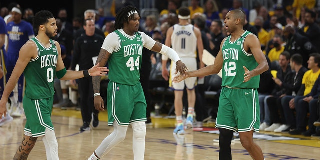 Boston Celtics forward Jayson Tatum (0) celebrates with center Robert Williams III (44) and center Al Horford (42) during the first half of Game 1 of the NBA Finals of basketball against the Golden State Warriors in San Francisco, Thursday June 2, 2022 (AP Photo/Jed Jacobsohn)