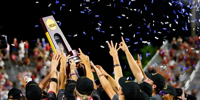 The Oklahoma Sooners celebrate by hoisting the NCAA trophy after defeating the Texas Longhorns during the NCAA Women's College World Series championship finals at the USA Softball Hall of Fame Complex on June 9, 2022 in Oklahoma City, Oklahoma.  Oklahoma won 10-5. 