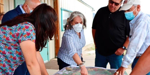 New Mexico's Gov. Michelle Lujan Grisham meets with local officials on wildfire damage in Mora County, June 7, 2022.