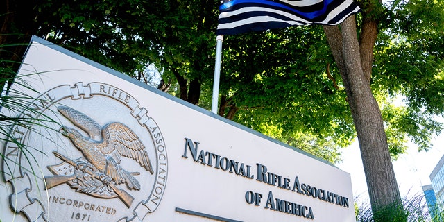 A thin blue line flag, signaling support for law enforcement, is displayed above the sign for the National Rifle Association (NRA) outside of its headquarters in Fairfax, Virginia, on May 31, 2022.