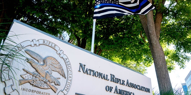 A thin blue line flag, signaling support for law enforcement, is displayed above the sign for the National Rifle Association (NRA) outside its headquarters in Fairfax, Virginia, on May 31, 2022.