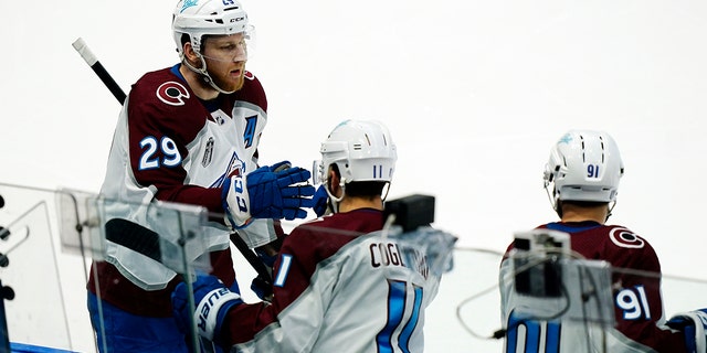 Colorado Avalanche center Nathan MacKinnon greets teammates after scoring during the second period of Game 6 of the NHL hockey Stanley Cup Finals against the Tampa Bay Lightning on Sunday, June 26, 2022, in Tampa, Fla.