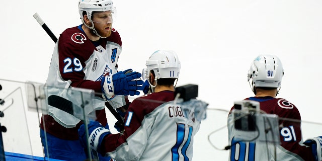 Colorado Avalanche center Nathan MacKinnon greets teammates after scoring during the second period of Game 6 of the NHL hockey Stanley Cup Finals against the Tampa Bay Lightning on Sunday, June 26, 2022, in Tampa, Fla.