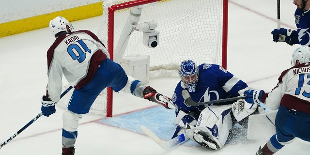 Colorado Avalanche center Nazem Kadri shoots the puck into the top of the goal past Tampa Bay Lightning goaltender Andrei Vasilevskiy (88) for a goal during overtime of Game 4 of the NHL hockey Stanley Cup Finals on Wednesday, June 22, 2022, in Tampa, Fla.