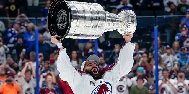 Colorado Avalanche center Nazem Kadri, #91,  hoisting the Stanley Cup during the NHL Hockey Stanley Cup Finals Game six between Tampa Bay Lightning and the Colorado Avalanche on June 26th, 2022 at Amalie Arena in Tampa Florida.