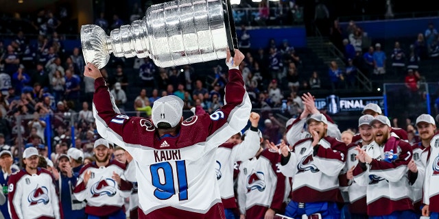 Colorado Avalanche center Nazem Kadri, #91, hoisting the Stanley Cup during the NHL Hockey Stanley Cup Finals Game six between Tampa Bay Lightning and the Colorado Avalanche on June 26th, 2022 at Amalie Arena in Tampa Florida.