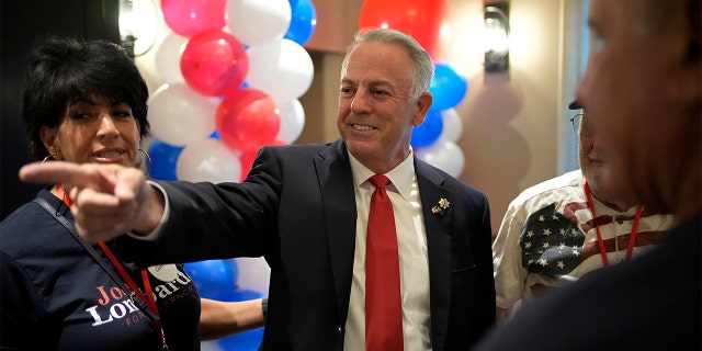 Republican candidate for Nevada governor, Joe Lombardo, center, is a former Clark County Sheriff. 