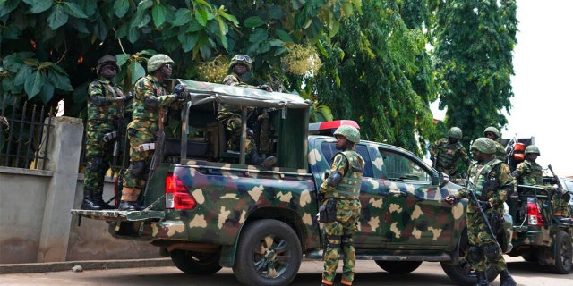 FILE: Nigerian soldiers secure the area outside of the St. Francis Catholic Church in the town of Owo, Nigeria, Monday, June 6, 2022, a day after an attack that targeted worshipers.
