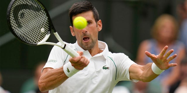 Serbia's Novak Djokovic returns to Korea's Kwon Soonwoo in a men's first round singles match on day one of the Wimbledon tennis championships in London, Monday, June 27, 2022. 